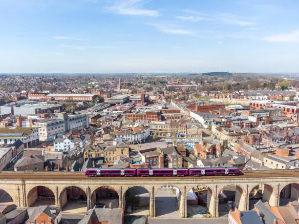 Photo of Mansfield England Cityscape aerial view of town with big long stone railway viaduct arches train passing over bridge with town and old market place from high view summer sky