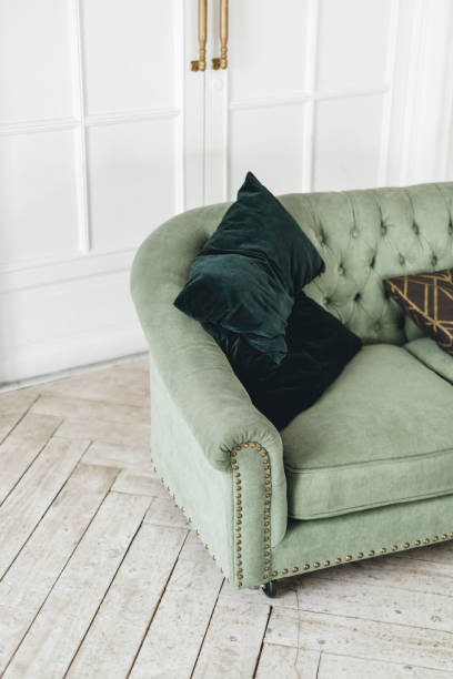 istock Green comfortable sofa in bright living room with minimalist interior. 1310787475