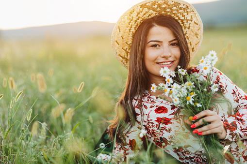 Serie of photos of female model in green dress posing on meadow. Outdoor portrait with natural light.