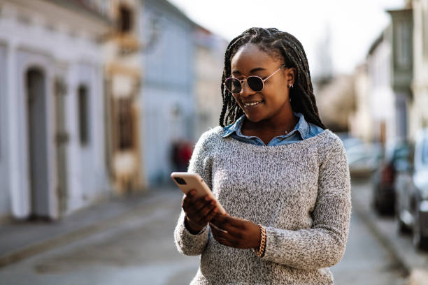 istock African American woman using phone in downtown 1310795198