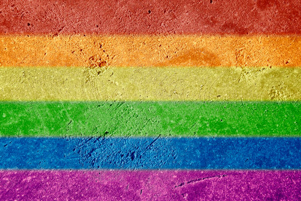 istock LGBTQ rainbow flag with horizontal stripes painted on stucco wall background. Pride day concept. 1310797061