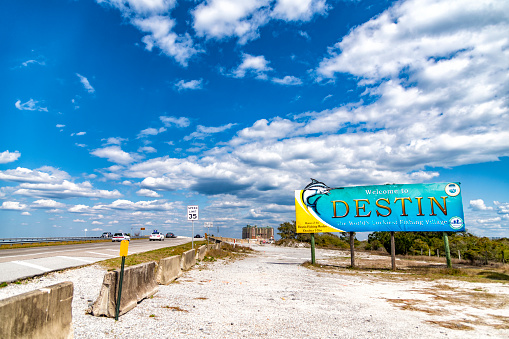Destin, United States - March 6, 2021:  The welcome sign at the city limits into the beautiful gulf coast town of Destin located along the panhandle of the state of Florida, USA.