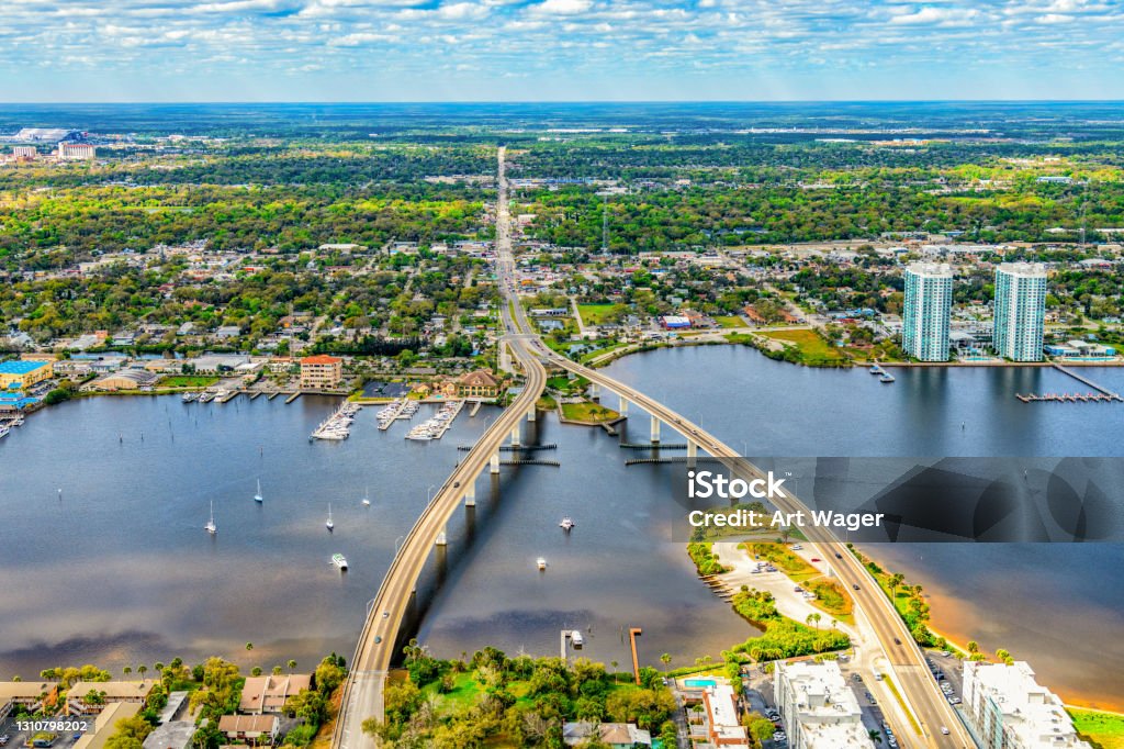 Daytona Beach Aerial The dual bridge crossing the Halifax River from the coast of Daytona Beach, Florida and merging into one main city street on the far side shot from an altitude of about 1000 feet. Merging Stock Photo