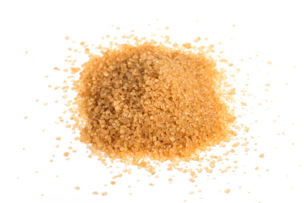 istock Brown sugar on a white background. Unrefined Cable Crystal Sugar 1310800490