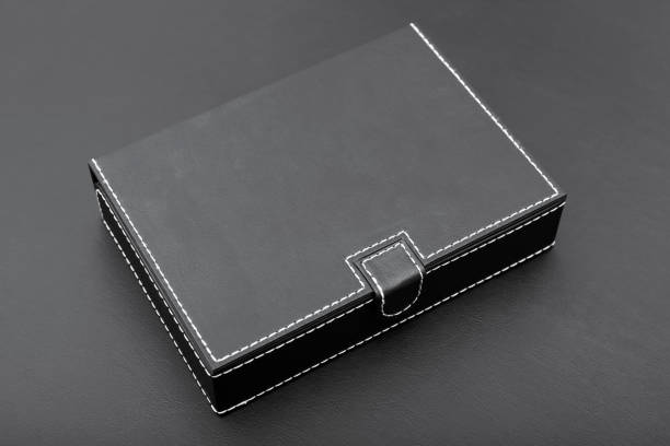 Closed black leatherette document box on a black table in the office.
