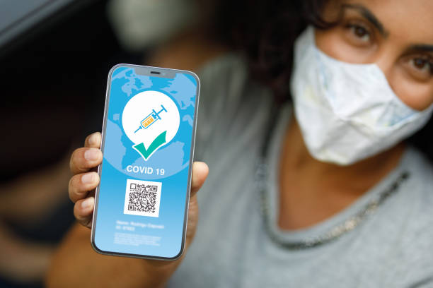 istock Woman showing her vaccination digital passport 1310801407