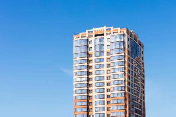 istock Multi-storey residential building against blue sky. Clean place for text 1310801632