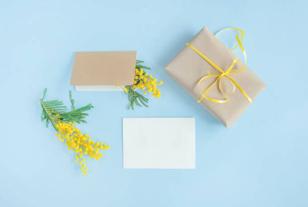 istock Gift and flowers on blue background. 1310801686