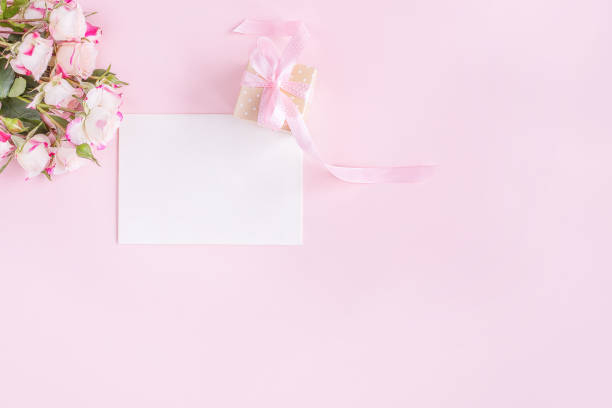 istock Gift, flowers and greeting card on pink background. 1310801701