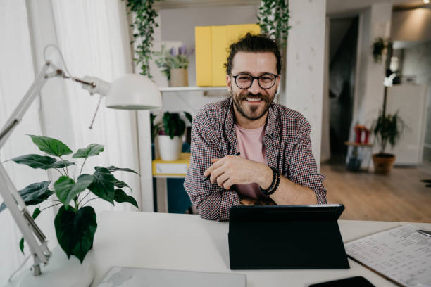 istock Young man working at home office 1310809096