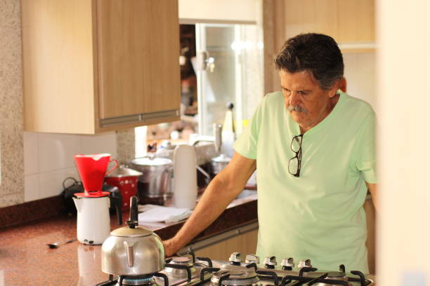 istock senior man making his coffee at home 1310810589