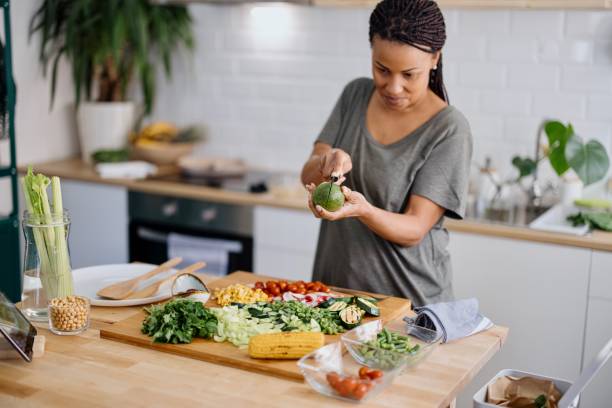 istock Woman cutting avocado for salad 1310812318