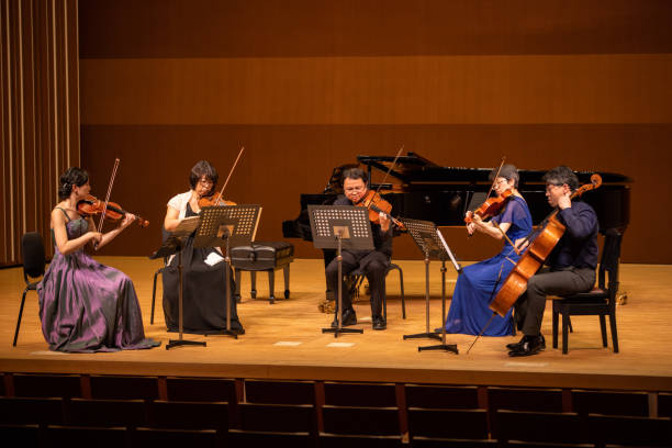 istock Five musicians playing violin, viola, and cello at classical music concert 1310813923