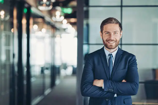 Portrait of a businessman standing in the office with arms crossed