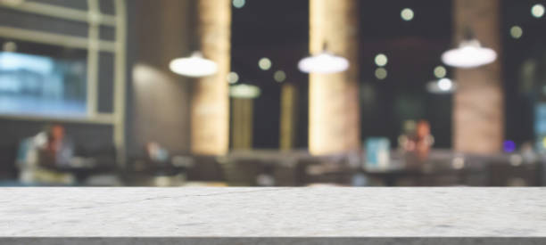istock marble table top with blurred abstract cafe restaurant interior background 1310818400
