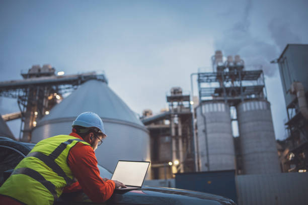 istock Responsible young enginner using a laptop during night shift in oil and gas industry. 1310818453