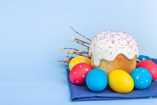 istock Easter russian cake and colorful eggs, flower on blue background. 1310822969