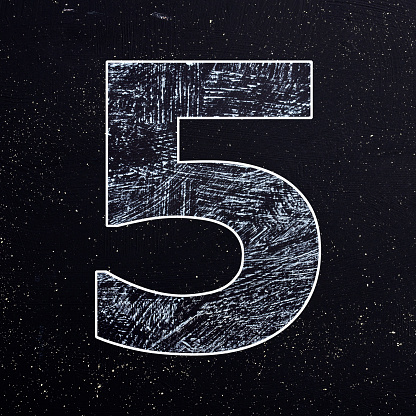 Number 5 written with chalk on the blackboard