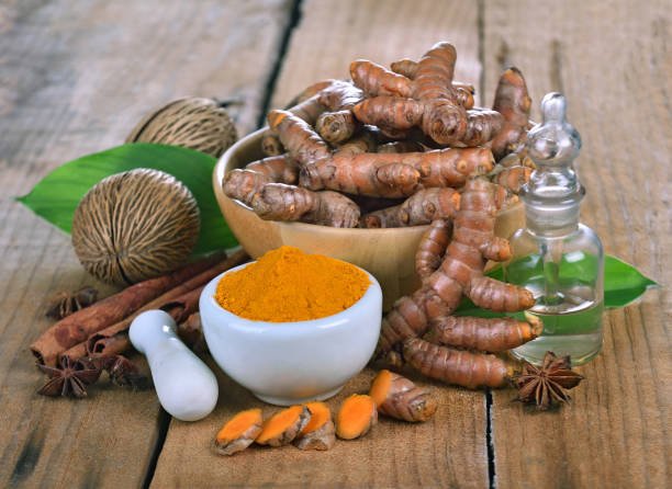 istock Turmeric powder in white dish on wooden background 1310827559