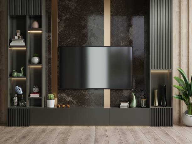 istock Mockup a TV wall mounted in a dark room with a dark marble wall. 1310831407
