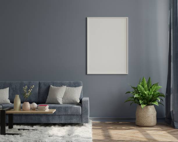 istock Interior poster mockup with vertical empty wooden frame standing on wooden floor with sofa on dark background. 1310831434