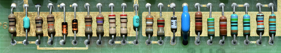 A line of old dusty resistors from a very old computer board.