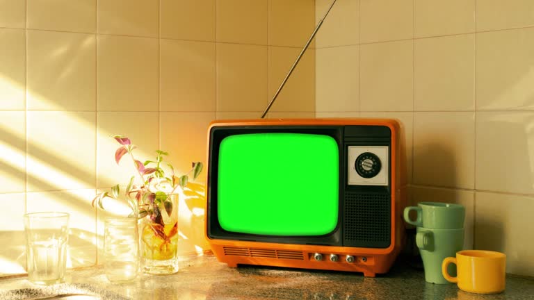 Retro television on a kitchen counter with chroma key screen