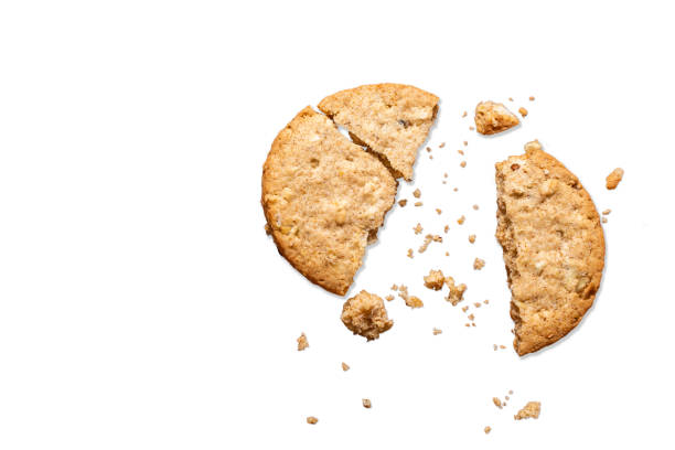 istock Whole grain biscuit with halved oats on white background and copy space. 1310833114