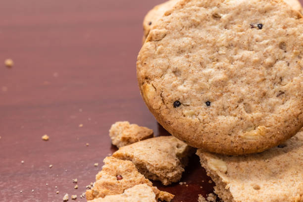 istock Broken wholemeal biscuit on wooden table with copy space. 1310833157