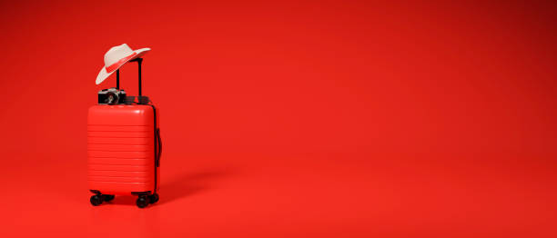istock 3D rendering, travel concept red baggage, camera and hat on red background 1310839613