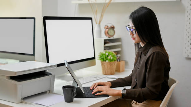 istock Female office worker working with digital tablet on computer desk 1310839623