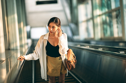 Woman on escalator in subway