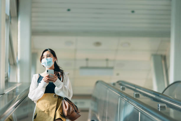 istock Woman with mask in station 1310846256