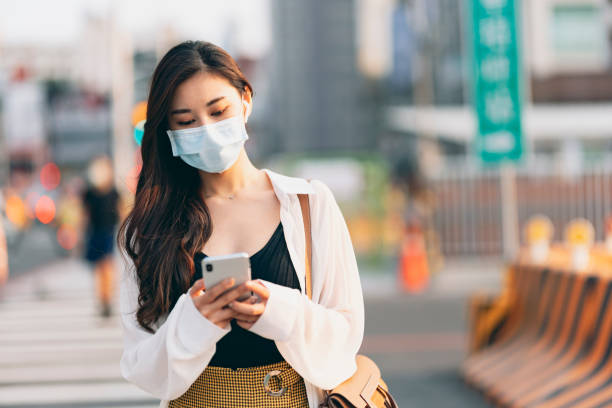 istock Asian young business woman with protective face mask 1310846286