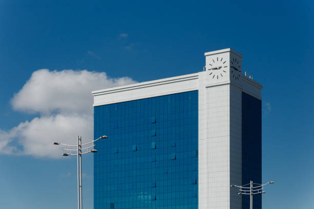 istock Modern glass building exterior. building with a clock 1310846415