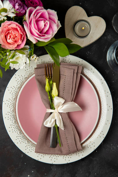 istock Wedding table setting concept. Plate, cutlery on linen napkin and flowers, top view, vertical photo 1310847282