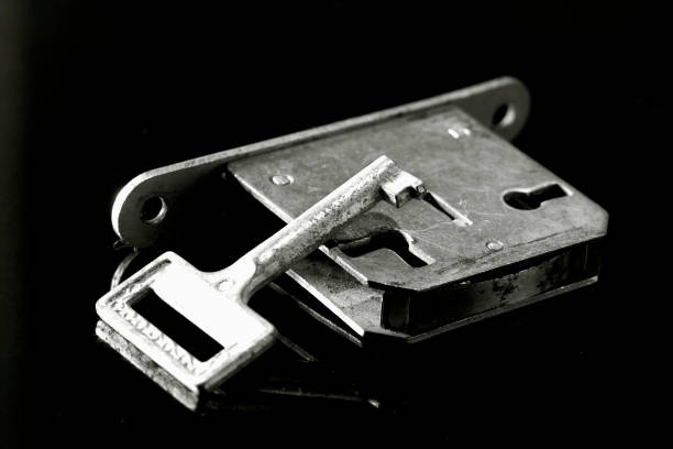 istock An old door lock and a key on black background 1310847410