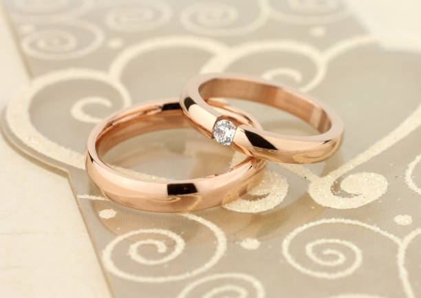 istock wedding bands with diamond on golden background 1310848149