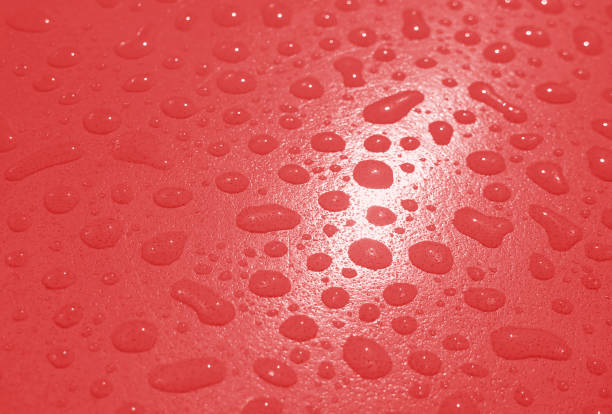 Red colored water droplets on the tabletop after the rain