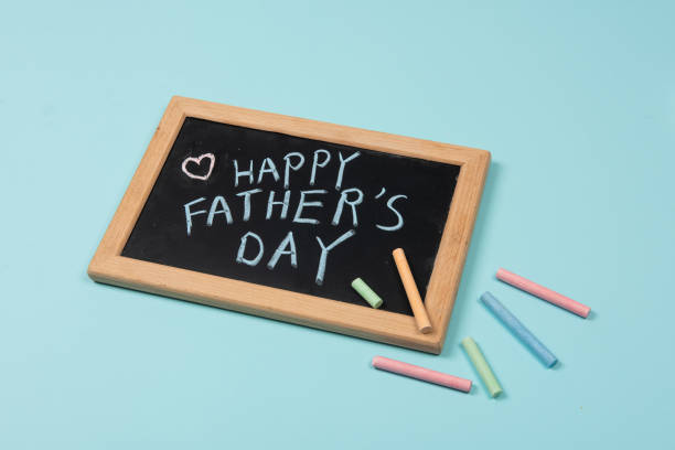 istock Happy Fathers Day written on chalkboard with chalk on blue background 1310849363