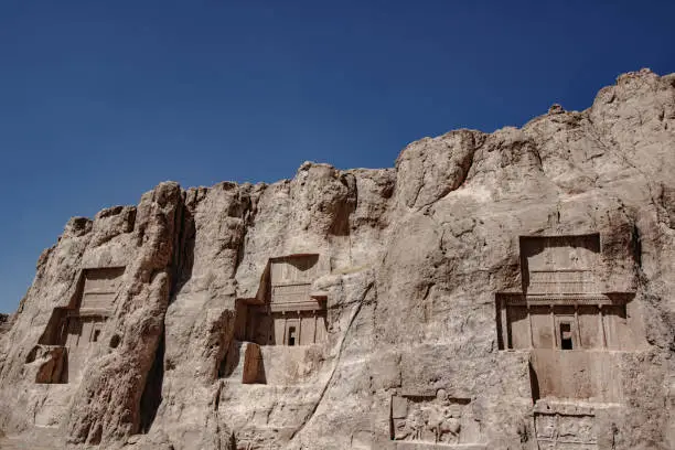 Three tombs of Persian Kings carved into the living rock. Ancient necropolis of Nasq-e rostam, near to Persepolis