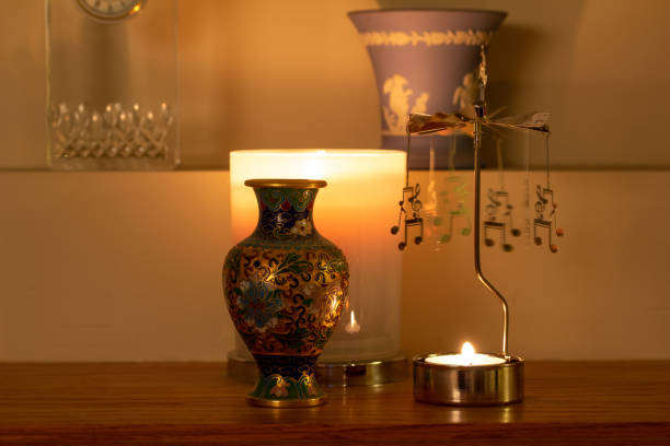 istock Close-up abstract view of a mantel shelf of small objects illuminated by candlelight 1310850302