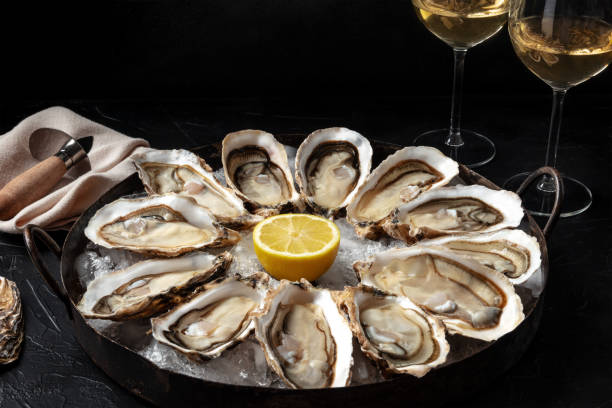 istock A dozen of oysters with lemon and wine 1310852325