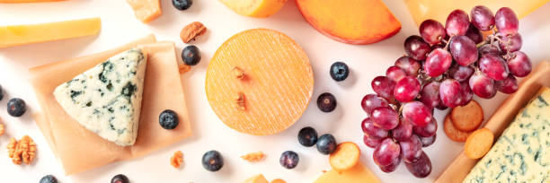 istock Cheese and grapes flat lay panorama on white 1310852349