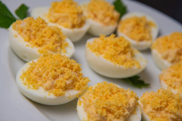 istock Stuffed eggs with crab crumbs, mayonnaise and parsley macro on a plate 1310852506