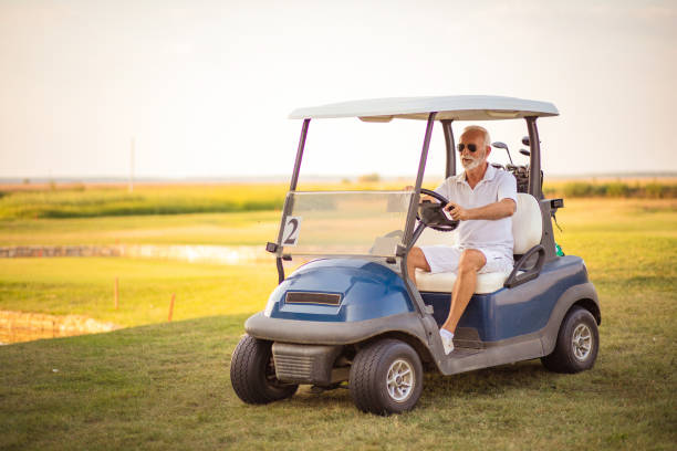 istock Senior man driving golf car. 1310853275