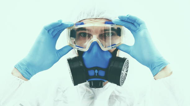 istock professional disinfector, looking at you through safety glasses 1310854479