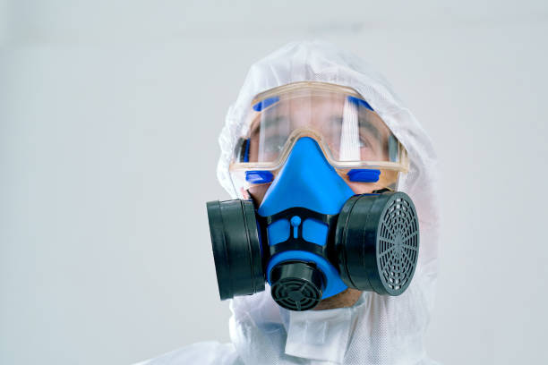 istock man in a hazmat suit, a respirator and a protective mask 1310854525