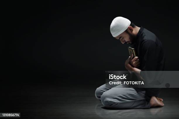 Religious Asian Muslim Man Holding Holy Quran Stock Photo - Download Image Now - Islam, Praying, Men