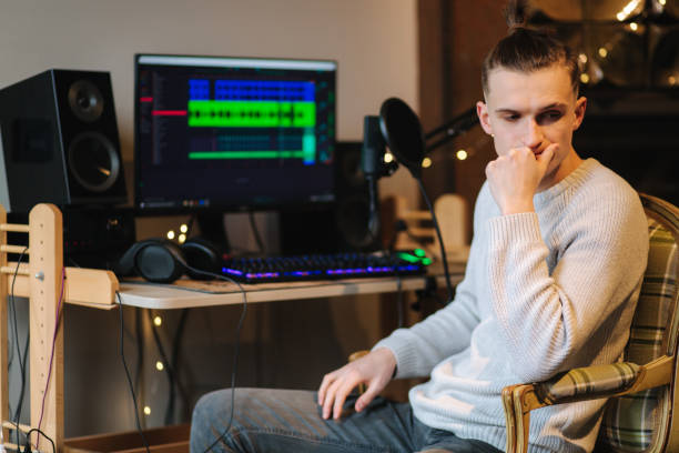 istock Sad man sitting in front of computer after unsuccessful and measuring work with different program with sound remix 1310858276